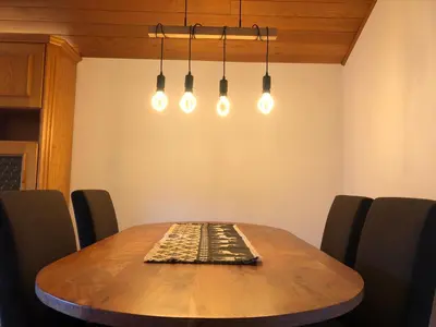 a dining room table with a rug on top of it at Apartments Rainer - Val Gardena in Ortisei