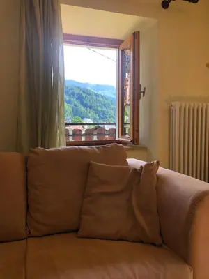 a bedroom with a bed and a dresser and a mirror at Case vacanze Desiree in Falcade