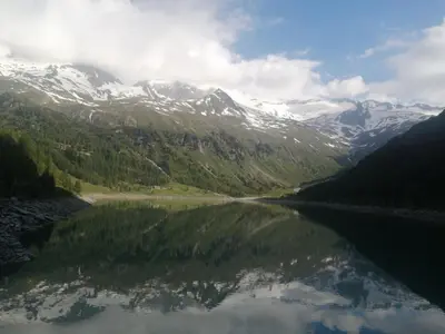 a view of a mountain reflecting in a lake at Appartement Sonneck in Lappago