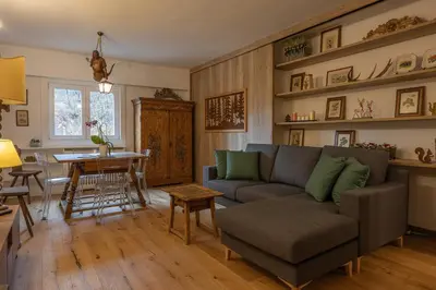 a living room with a couch and a table at Casa Maia in Cortina dʼAmpezzo