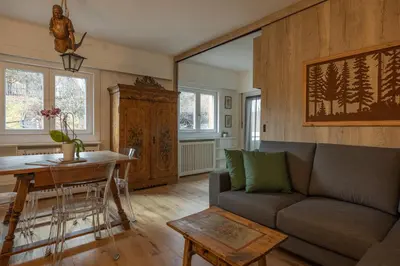 a living room with a couch and a table at Casa Maia in Cortina dʼAmpezzo