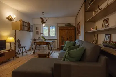 a living room with a couch and a table at Casa Maia in Cortina dʼAmpezzo