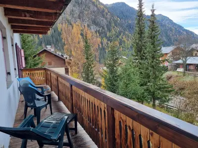 a balcony with chairs and a view of a mountain at Casa Riz in Campitello di Fassa