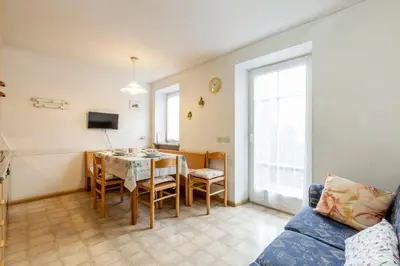 a living room with a table and a couch at Casa Riz in Campitello di Fassa
