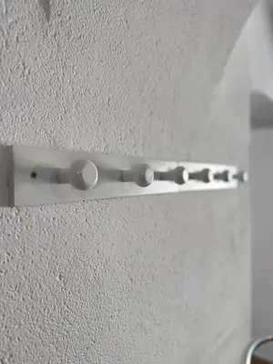 a metal door handle on a white wall at Appartamento incantevole Fondo Val di Non in Fondo