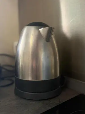 a metal kettle sitting on top of a table at Appartamento incantevole Fondo Val di Non in Fondo