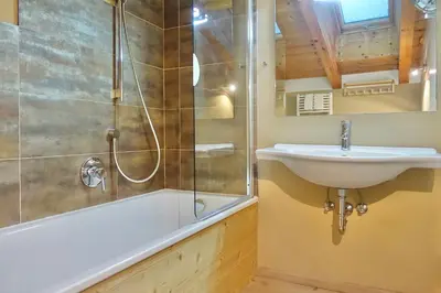 a green curtain in a bedroom with a bed at Apartments DA LA VEDLA Flats in San Cassiano