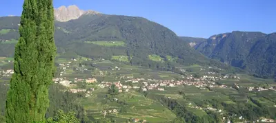 a view of a village in a valley with mountains at Zagler Appartments in Tirolo