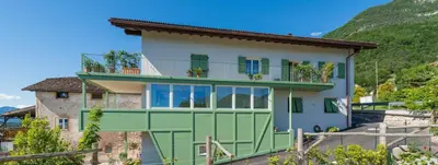 a house with a green and white at Haus Pobitzer in Caldaro
