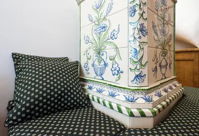 a couch with a pillow and a vase on it at Appartamento 4 posti letto in Borca di Cadore