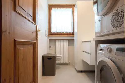 a small bathroom with a toilet and a window at Appartamento 4 posti letto in Borca di Cadore