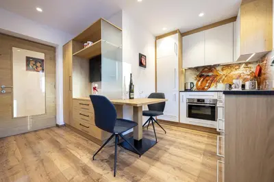 a kitchen with a wooden table and chairs at Apartment Fina in Ortisei