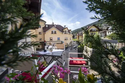 a table and chairs in front of a building at Apartment Fina in Ortisei