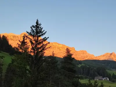 a view of a mountain with a house and trees at Apartments B&B Pretermo in Badia