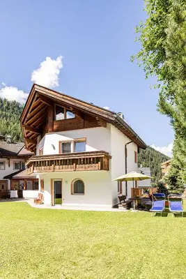 a kitchen with a table and chairs in a room at Chalet Merisana in Selva di Val Gardena