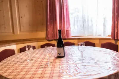 a large room with a door and a living room at Chalet Merisana in Selva di Val Gardena