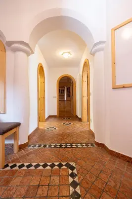 an empty hallway of a building with a checkered floor at Chalet Merisana in Selva di Val Gardena