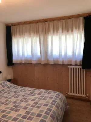 a bedroom with a bed and a window at Casa Gallo in Mazzin