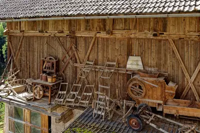 a wooden shed with chairs and a table and a group thereof at Kehrerhof Urlaub auf dem Bauernhof in San Lorenzo di Sebato
