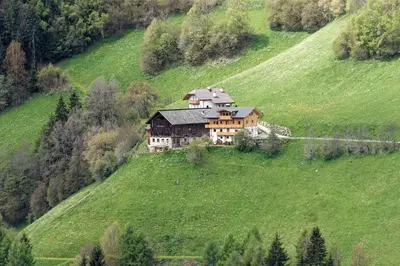 a house on a hill in a green field at Kehrerhof Urlaub auf dem Bauernhof in San Lorenzo di Sebato