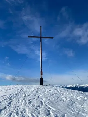 a large cross on top of a snow covered hill at Kehrerhof Urlaub auf dem Bauernhof in San Lorenzo di Sebato