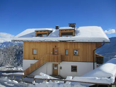 a house with a snow covered roof on a mountain at Kehrerhof Urlaub auf dem Bauernhof in San Lorenzo di Sebato