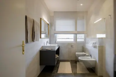 a bathroom with a sink and a toilet at Hotel Bruneck Design-Suites in Brunico