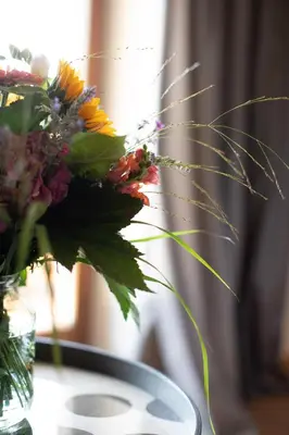 a vase of flowers sitting on a table at Nössinghof in Tirolo