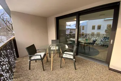 a dining room with a glass table and chairs at Riversuite in Bressanone