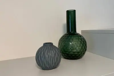 two vases sitting on a table with a vase at Riversuite in Bressanone