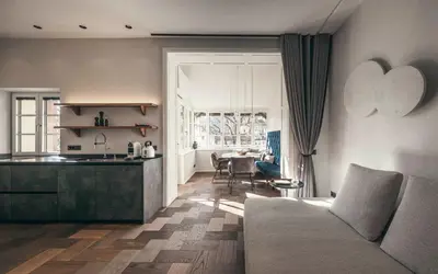 a kitchen and living room with a couch and a table at Apartment 901 in Bressanone