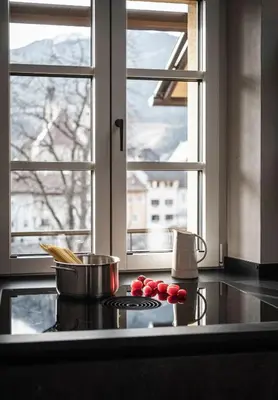 a kitchen with a stove top oven next to a window at Apartment 901 in Bressanone