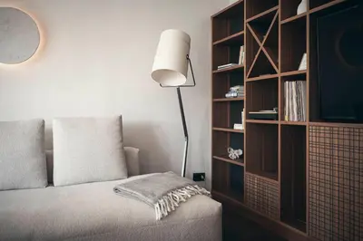 a bedroom with a bed and a book shelf at Apartment 901 in Bressanone