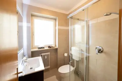 a bathroom with a toilet and a sink and a shower at Ferienwohnung am Kalterer See in Südtirol in Caldaro