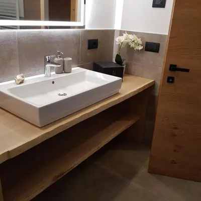 a bathroom with a white sink and a mirror at Rooftop-Schenna in Schenna