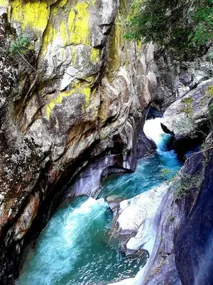 a river flowing through a rocky canyon with blue water at Rooftop-Schenna in Schenna