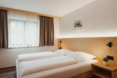 a bedroom with two beds and a window at Apartments Roda de Ciar in Badia