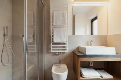 a bathroom with a sink and a shower at Apartments Roda de Ciar in Badia
