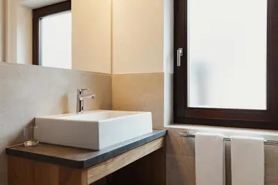 a bathroom with a white sink and a mirror at Apartments Roda de Ciar in Badia