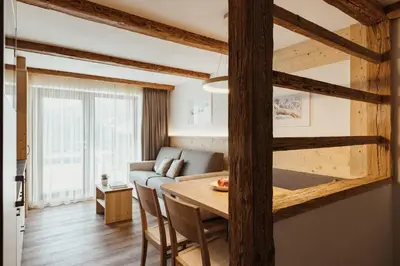 a living room with a table and a couch at Apartments Roda de Ciar in Badia