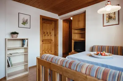 a room with a table with a bowl of fruit on it at Apartments Roda de Ciar in Badia