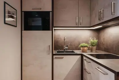 a kitchen with wooden cabinets and a sink at Apartments Roda de Ciar in Badia