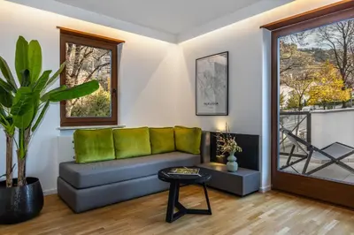 a living room with a couch and a table at Palm Loggias Meran in Merano