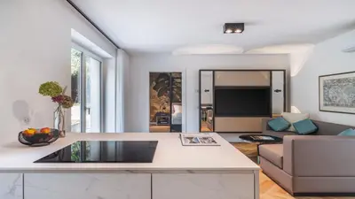 a living room with a couch and a table at Palm Loggias Meran in Merano
