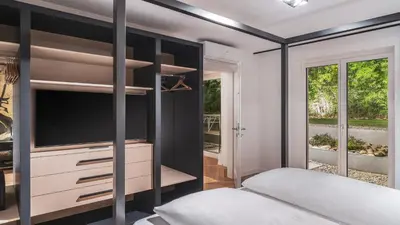 a bedroom with a bed and a tv at Palm Loggias Meran in Merano