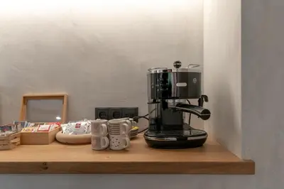 a coffee maker sitting on a wooden shelf at Ciasa Iachin - Dolomites Dream Retreat in San Martino in Badia