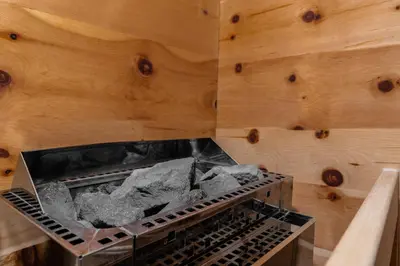 a stove with a bunch of rocks inside of it at Ciasa Iachin - Dolomites Dream Retreat in San Martino in Badia