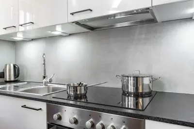 a kitchen with two pots and a sink at Ciasa Iachin - Dolomites Dream Retreat in San Martino in Badia