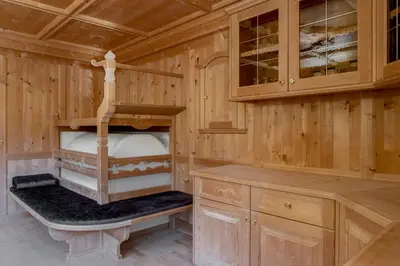 a wooden cabin with a bunk bed in it at Ciasa Iachin - Dolomites Dream Retreat in San Martino in Badia