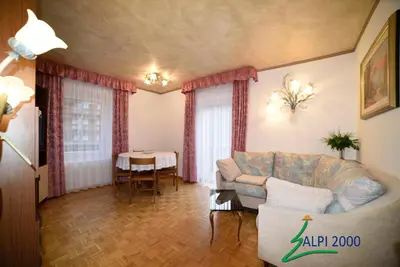 a living room with a couch and a table at Casa Dolomiti - BERTA in Campitello di Fassa